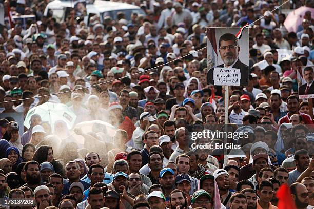 Supporters of deposed Egyptian President Mohammed Morsi demonstrate at the Rabaa al-Adweya Mosque in the Nasr City district on July 8, 2013 in Cairo,...