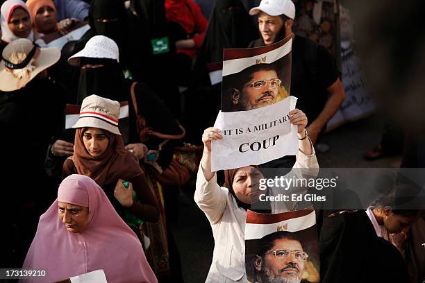 Supporters of deposed Egyptian President Mohammed Morsi demonstrate at the Rabaa al-Adweya Mosque in the Nasr City district on July 8, 2013 in Cairo,...