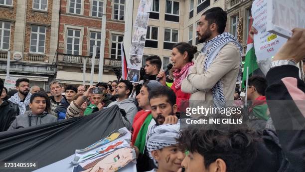 People attend a pro Palestinian solidarity action at the Martelarenplein in Leuven, Wednesday 18 October 2023. Hamas launched a large-scale attack on...
