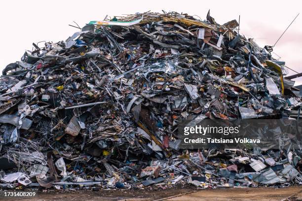 photo of imposing mountain of unidentifiable scrap metal - environmental stewardship stock pictures, royalty-free photos & images