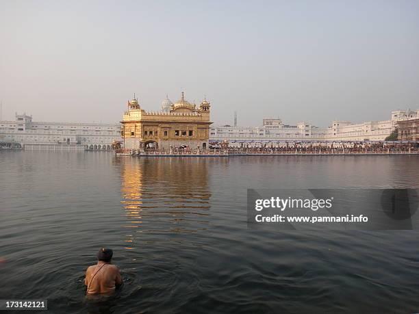 the holy dip ! - baisakhi stock pictures, royalty-free photos & images