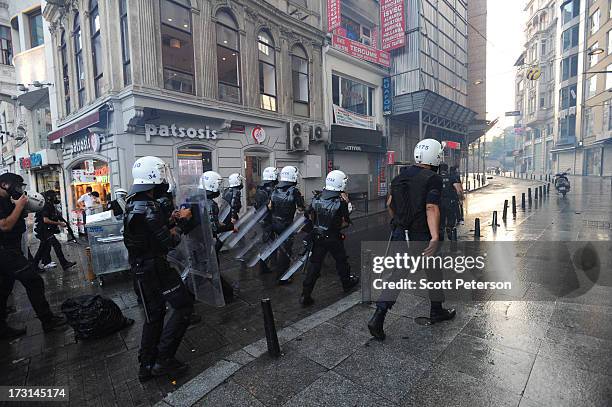 Turkish riot police advance as they battle anti-government protestors along the Istiklal shopping street near Taksim Square on July 8, 2013 in...