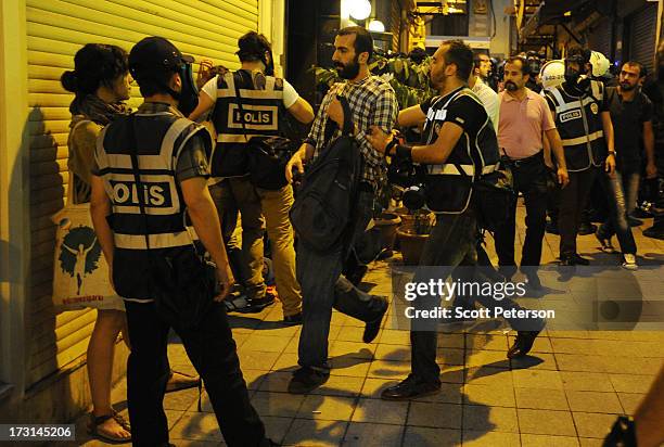 Turkish police make arrests as they pursue anti-government protestors along the Istiklal shopping street near Taksim Square on July 8, 2013 in...