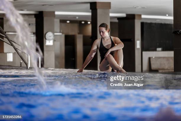 woman in black swimsuit sitting on the edge of a spa whirlpool - algar waterfall spain stock pictures, royalty-free photos & images