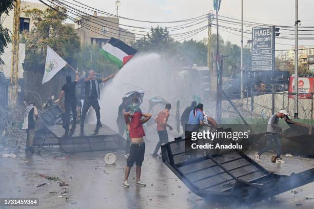 Security forces intervene with tear gas and water cannon to Palestinian refugees and Lebanese during the demonstration in solidarity with Gaza and...