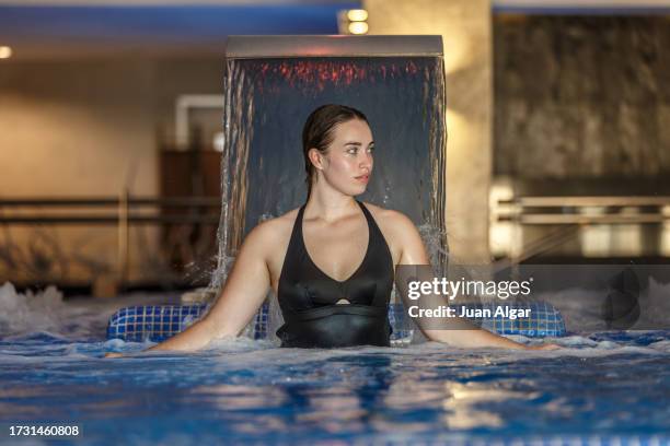 young woman in bathing suit relaxing in a spa pool - algar waterfall spain stock pictures, royalty-free photos & images