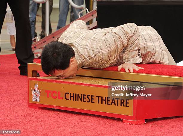 Actor Jackie Chan poses at his hand/footprint cement ceremony at TCL Chinese Theatre on June 6, 2013 in Hollywood, California.