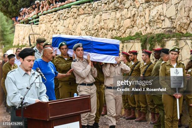 Soldiers carry the casket of Valentin Ghnassia who was killed in a battle with Hamas militants at Kibbutz Be’eeri near the Israeli border with the...