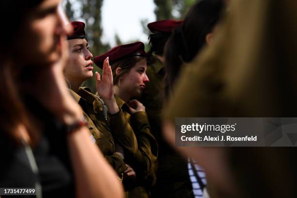 Soldiers cry during the the funeral of Valentin Ghnassia who was killed in a battle with Palestinian militants at Kibbutz Be’eeri near the Israeli...