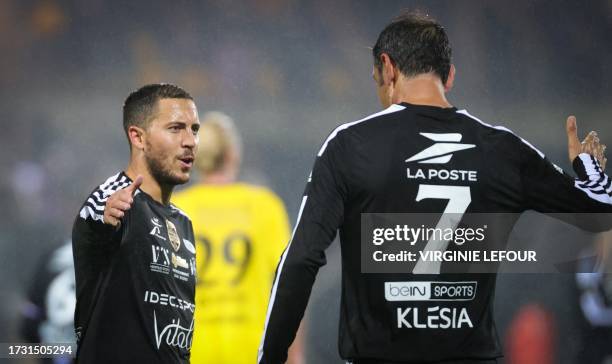 Belgium's Eden Hazard and VCL's Robert Pires celebrate after scoring during a gala soccer game between Variety Club France with various...