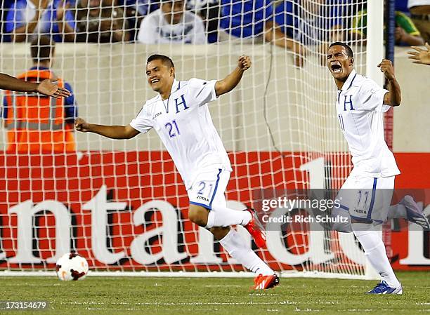 Midfielder Rony Martinez of Honduras celebrates his goal with forward Roger Rojas after scoring during the first half against Haiti of a 2013...