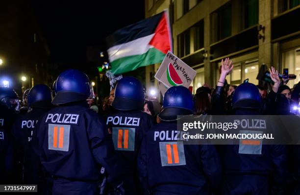 German riot police officers push back Pro-Palestinian demonstrators as they protest against the bombing in Gaza outside the Foreign Ministry in...