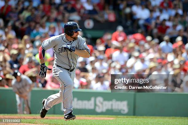 Mark Kotsay of the San Diego Padres runs to first base in the third inning against the Boston Red Sox at Fenway Park on July 4, 2013 in Boston,...