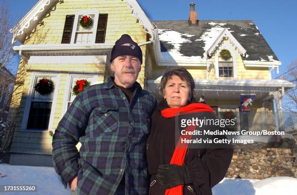 Somerville, MA--Sonny and Claudine Oleson of Somerville stand in front of their home.