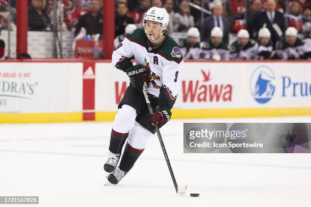 Arizona Coyotes right wing Clayton Keller skates with the puck during a game between the Arizona Coyotes and New Jersey Devils on October 13, 2023 at...