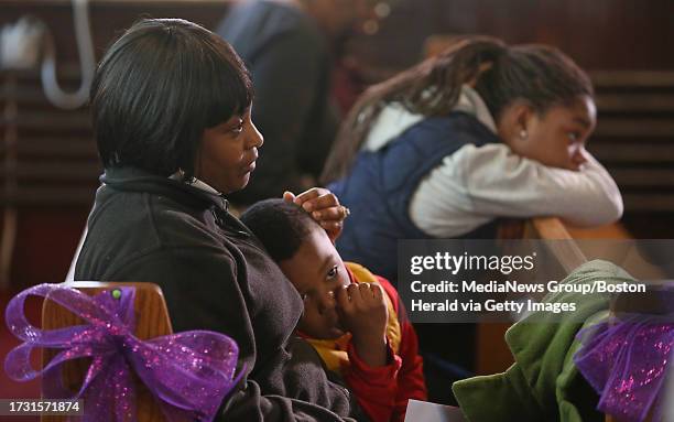 Sabrina Gilliard and her son Keylin Taylor of Roxbury listen as District Attorney Dan Conley talks during the Women Survivors of Homicide event at...