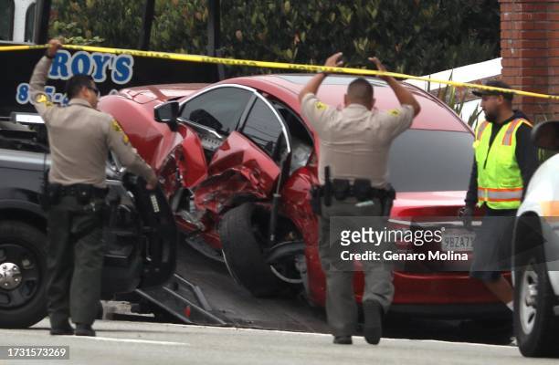 Sheriff deputies approach the scene where four women were killed in a multi-vehicle crash in Malibu on October 18, 2023. A 22-year-old man was...