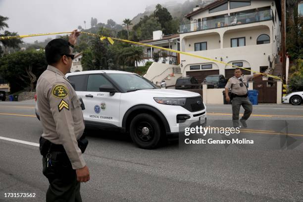 Sheriff deputies lift the yellow tape for a Medical Examiner car leaving the scene where four women were killed in a multi-vehicle crash in Malibu on...