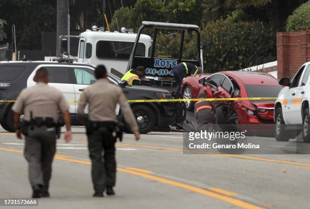 Sheriff deputies approach the scene where four women were killed in a multi-vehicle crash in Malibu on October 18, 2023. A 22-year-old man was...