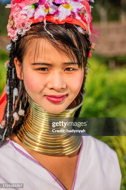 woman from long neck karen tribe crossing rice field - padaung tribe stock pictures, royalty-free photos & images