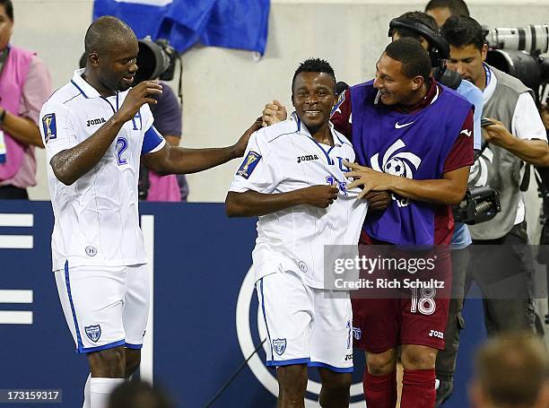 Midfielder Marvin Chavez of Honduras is congratulated by teammates defender Osman Chavez and backup goalkeeper Kevin Hernandez after he scored a goal...