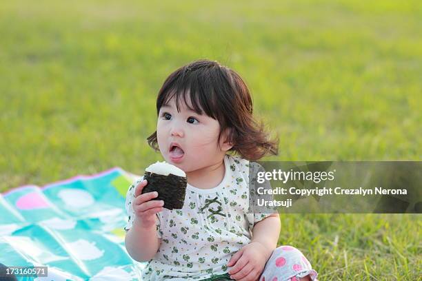 baby with rice ball - rice ball stockfoto's en -beelden
