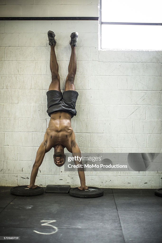 Man doing handstand pushups