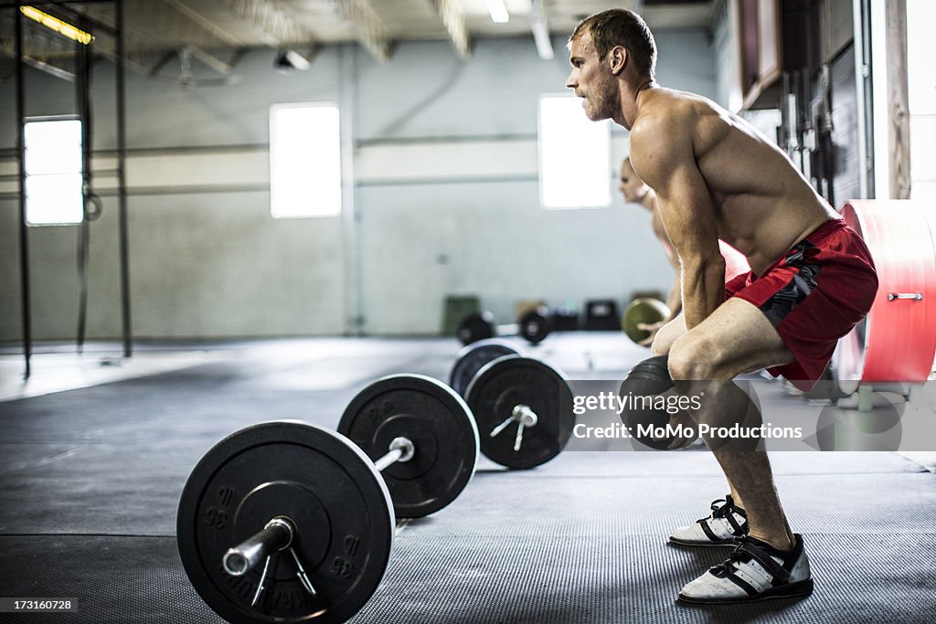 Man doing gym medicine ball slams