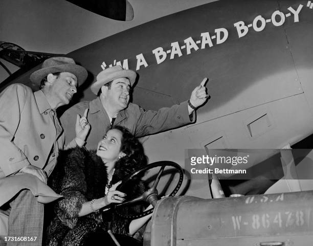 American comedians Bud Abbott and Lou Costello are pictured with actress Merle Oberon at a military base in Long Beach, California, December 18th...