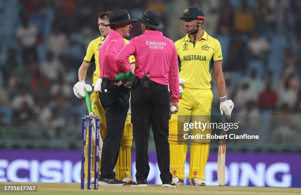 Marcus Stoinis and Marnus Labuschagne of Australia interacts with Match Umpire Richard Illingworth after being dismissed from a review during the ICC...