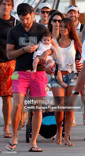 Cesc Fabregas , his daughter Lia Fabregas and Leo Messi's girlfriend Antonella Rocuzzo are seen on July 8, 2013 in Ibiza, Spain.