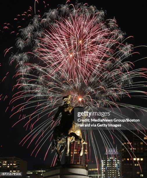 Fireworks explode over the George Washington Statue and the Boston Common and Public Gardens at the First Night celebration. Wednesday, December 31,...