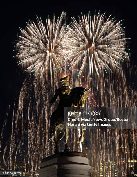 Fireworks explode over the George Washington Statue and the Boston Common and Public Gardens at the First Night celebration. Wednesday, December 31,...