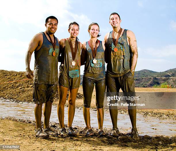 four friends competing in a mud run(18-25) yrs. - awards portraits stock pictures, royalty-free photos & images