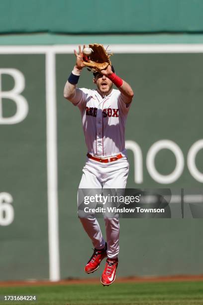 Trevor Story of the Boston Red Sox grabs a line drive against the New York Yankees during the first inning of game one of a doubleheader at Fenway...