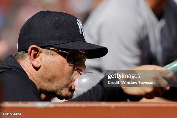 Manager Aaron Boone of the New York Yankees looks on from the dugout during the first inning of game one of a doubleheader against the Boston Red Sox...