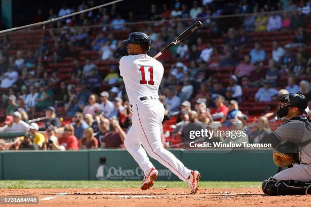 Rafael Devers of the Boston Red Sox follows through on a hit against the New York Yankees during the first inning of game one of a doubleheader at...