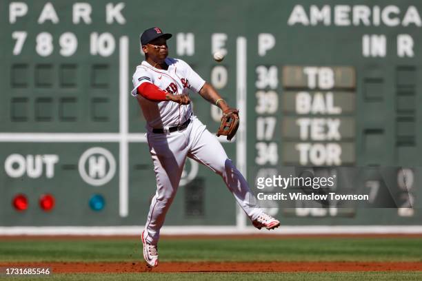 Rafael Devers of the Boston Red Sox throws out a runner against the New York Yankees during the first inning of game one of a doubleheader at Fenway...