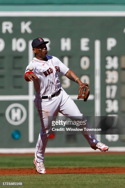 Rafael Devers of the Boston Red Sox throws out a runner against the New York Yankees during the first inning of game one of a doubleheader at Fenway...