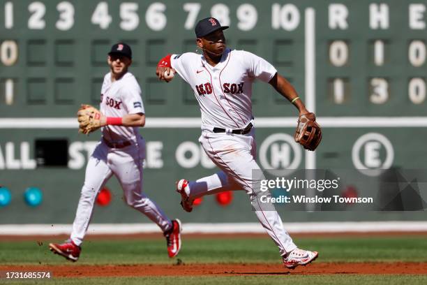 Rafael Devers of the Boston Red Sox throws out a runner against the New York Yankees during the first inning of game one of a doubleheader at Fenway...