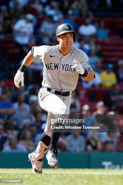 Anthony Volpe of the New York Yankees runs out a hit against the Boston Red Sox during the sixth inning of game one of a doubleheader at Fenway Park...