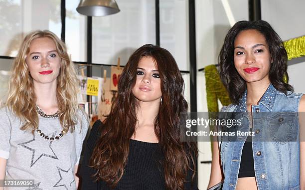 Selena Gomez poses with models during a photocall to launch the Selena Gomez by adidas NEO collection on July 9, 2013 in Berlin, Germany.