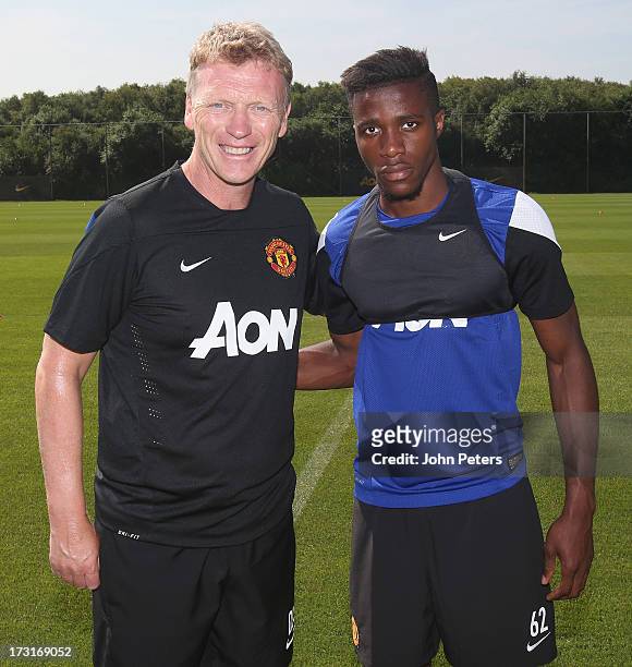 Manager David Moyes of Manchester United poses with Wilfried Zaha ahead of a first team training session at the Aon Training Complex on July 9, 2013...