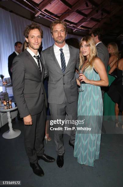 Psychic entertainer Lior Suchard, Gerard Butler and guest attend the Novak Djokovic Foundation inaugural London gala dinner at The Roundhouse on July...