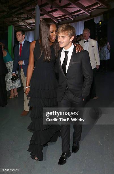 Naomi Campbell and a guest attend the Novak Djokovic Foundation inaugural London gala dinner at The Roundhouse on July 8, 2013 in London, England....