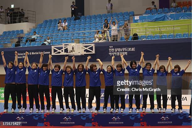 Team Japan celebrate victory on the podium after defeating Iran during the Women's Futsal Gold Medal match at Songdo Global University Campus...