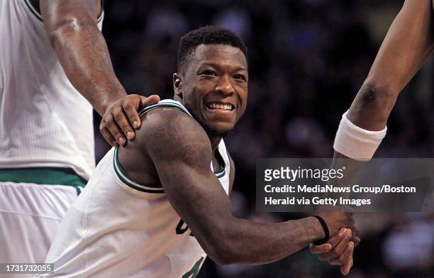Boston Celtics point guard Nate Robinson gets a hand from power forward Glen Davis and small forward Paul Pierce in the fourth quarter of an NBA game...