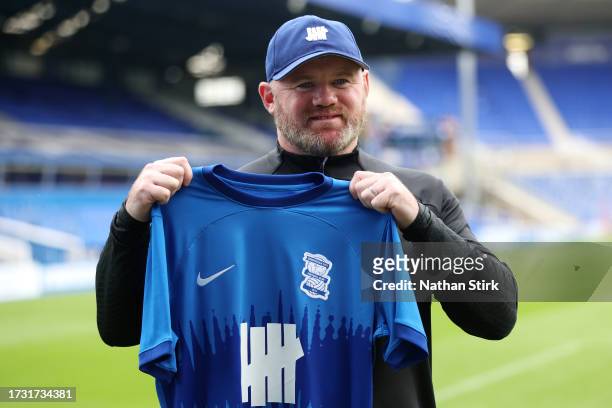 Wayne Rooney, Manager of Birmingham City holds up a Birmingham City home shirt as he is presented as new Birmingham City manager at St Andrew's...