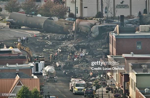 Search teams carry a large white bag out of the rubble in the town centre of Lac-MÈgantic during their search for the dead Monday evening. 40 more...