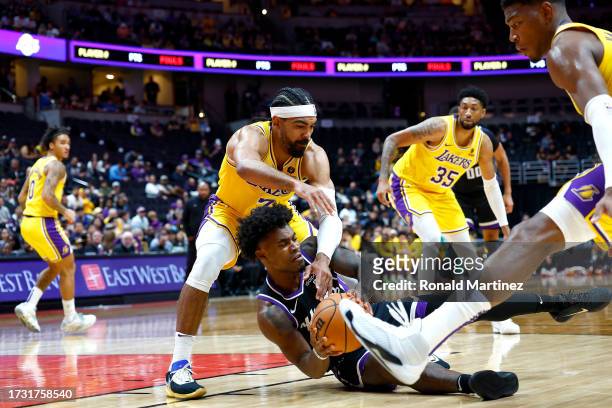 Davion Mitchell of the Sacramento Kings dives for the ball against Gabe Vincent of the Los Angeles Lakers in the first half at Honda Center on...